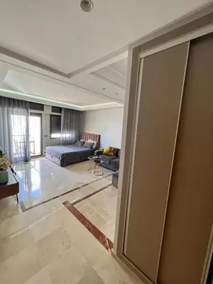 a living room with a bed and a couch at Large bright and centrally located studio in Casablanca