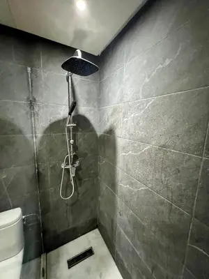 a shower with a shower head in a bathroom at Large bright and centrally located studio in Casablanca