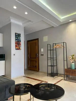 a living room with a couch and a table at Large bright and centrally located studio in Casablanca