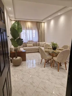 a living room with a couch and a table and chairs at Chez Maud Skhirat-Rabat in Skhirat