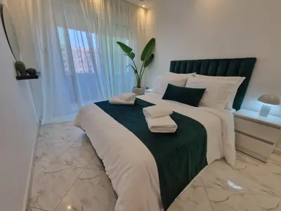 a bedroom with a large bed with towels on it at Chez Maud Skhirat-Rabat in Skhirat