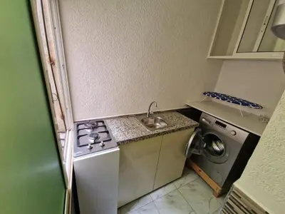 a small kitchen with a sink and a washing machine at Chez Maud Skhirat-Rabat in Skhirat