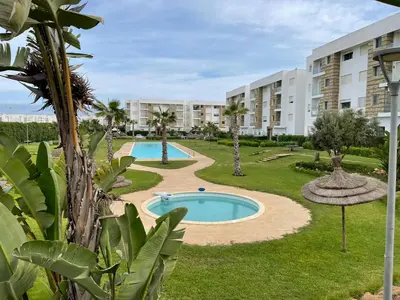 a view of an apartment complex with a swimming pool at APPART AMIR Belle Appartement avec pecine in Dar Bouazza