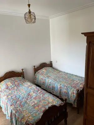two beds sitting next to each other in a room at APPART AMIR Belle Appartement avec pecine in Dar Bouazza