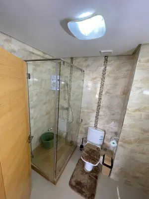 a bathroom with a glass shower and a toilet at APPART AMIR Belle Appartement avec pecine in Dar Bouazza