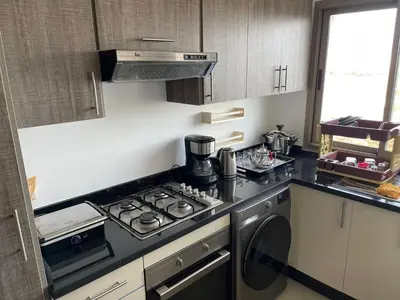 a kitchen with a stove and a stove top oven at APPART AMIR Belle Appartement avec pecine in Dar Bouazza