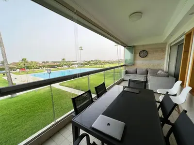 a room with a table and chairs and a large window at Ola Blanca in Sidi Rahal