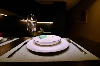 a table with a plate and a glass of wine at Luxurious and modern studio on Maarif-Franceville in Casablanca