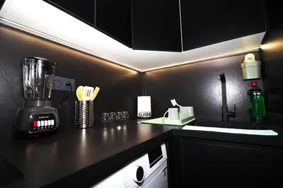 a kitchen with a black counter top with a blender at Luxurious and modern studio on Maarif-Franceville in Casablanca