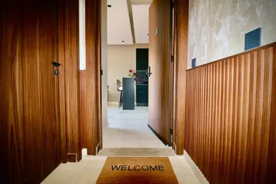 a hallway with a welcome mat on the floor of a building at Luxurious and modern studio on Maarif-Franceville in Casablanca