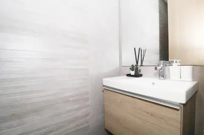 a bathroom with a white sink and a mirror at Studio luxueux sur Val d'anfa in Casablanca