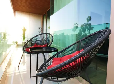 two black chairs and a table with red pillows at Studio luxueux sur Val d'anfa in Casablanca