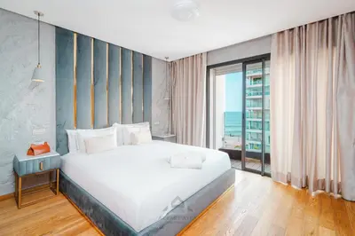 a bedroom with a large white bed and a window at TheBesty Ocean Apartment 2MBd- By Appart'Ayla in Casablanca