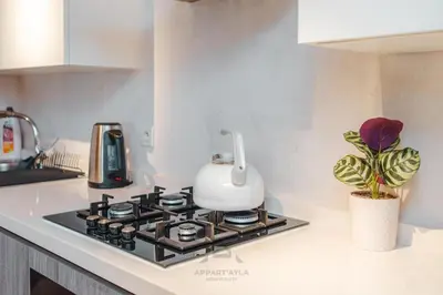 a kitchen stove with a tea kettle on top of it at TheBesty Ocean Apartment 2MBd- By Appart'Ayla in Casablanca