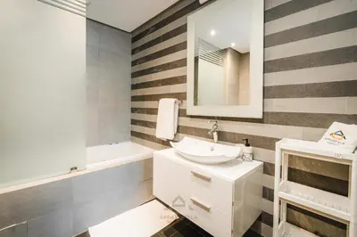 a bathroom with a sink and a mirror and a tub at TheBesty Ocean Apartment 2MBd- By Appart'Ayla in Casablanca