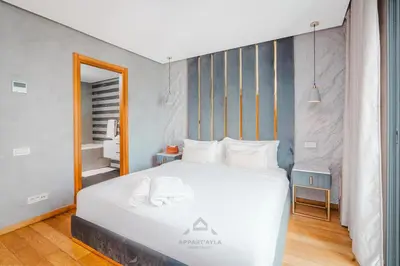 a bedroom with a large white bed in a room at TheBesty Ocean Apartment 2MBd- By Appart'Ayla in Casablanca