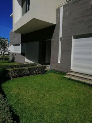 a house with a grass yard in front of it at Appartement Résidence balnéaire Dar Al bahr in Sidi Rahal