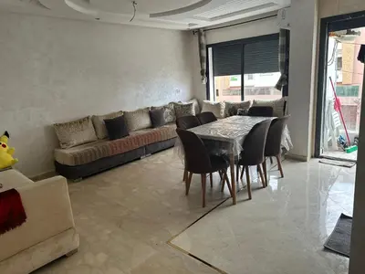 a living room with a table and a couch at Appartement vu sur mer in Pont Blondin