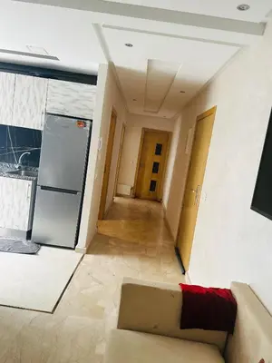 a living room with a couch and a kitchen at Appartement vu sur mer in Pont Blondin