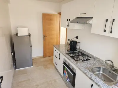 a kitchen with a sink and a refrigerator at Bab fes Appartement 2 pièces à Aïn Sebaâ Casablanca in Aïn Sebaa