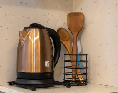 a tea kettle and spatula are sitting on a counter at Charmant et cosy appartement en plein centre ville in Casablanca