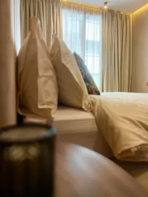a bedroom with a bed with pillows and a window at Rafina in Casablanca