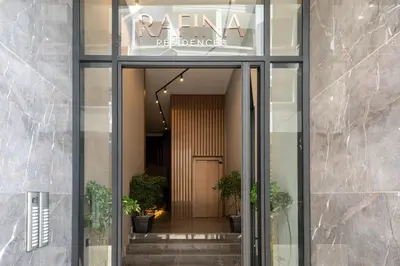 a glass door to a building with potted plants at Rafina in Casablanca