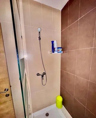 a bathroom with a shower and a toilet in it at Wifak beach rental in Temara