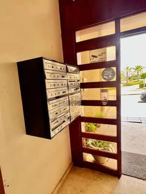 a wall with three drawers and a window at Wifak beach rental in Temara
