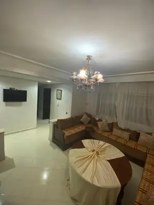 a living room with a couch and a chandelier at The White House in Casablanca
