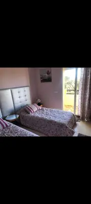a bedroom with two beds and a window at Bahia golf beach pavillon in Bouznika