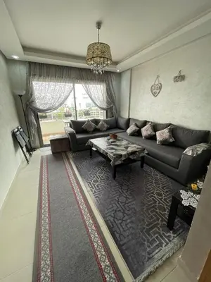 a living room with a couch and a table at Magnifique appartement à louer in Mohammedia