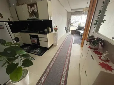 a room with a kitchen and a living room at Magnifique appartement à louer in Mohammedia