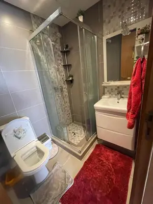 a bathroom with a shower and a toilet and a sink at Magnifique appartement à louer in Mohammedia
