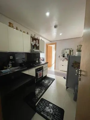 a kitchen with a stove and a sink and a refrigerator at Magnifique appartement à louer in Mohammedia