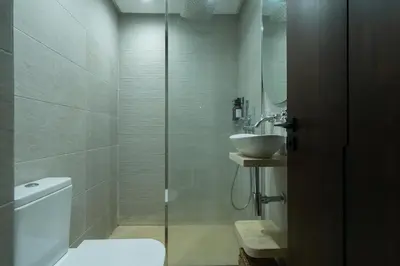 a bathroom with a shower and a toilet and a sink at Central Cosy 2BR 2 Baths, Balcony & Clear View in Casablanca