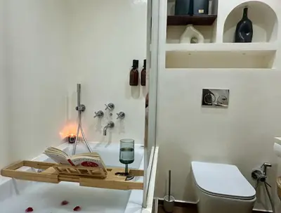 a bathroom with a book shelf and a toilet at Central Cosy 2BR 2 Baths, Balcony & Clear View in Casablanca