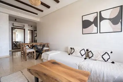 a living room with two beds and a table at Central Cosy 2BR 2 Baths, Balcony & Clear View in Casablanca