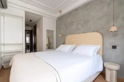 a bedroom with a large white bed with white pillows at Central Cosy 2BR 2 Baths, Balcony & Clear View in Casablanca