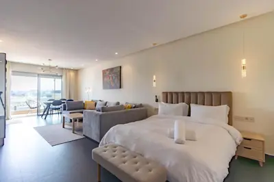 a bedroom with a large bed and a couch at Terrasse Horizon Marina in Casablanca