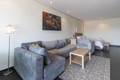 a living room with a couch and a table at Terrasse Horizon Marina in Casablanca