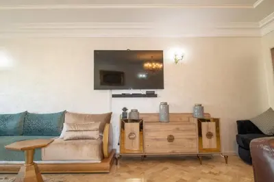 a living room with a couch and a tv at good Nice appartement in Casablanca