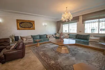 a large living room with couches and a chandelier at good Nice appartement in Casablanca