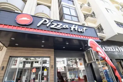 a pizza hut sign in front of a building at good Nice appartement in Casablanca