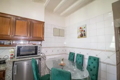 a kitchen with a table and chairs and a microwave at good Nice appartement in Casablanca