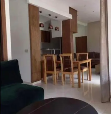 a living room with a table and some chairs at Costa Beach 2 in Bouznika