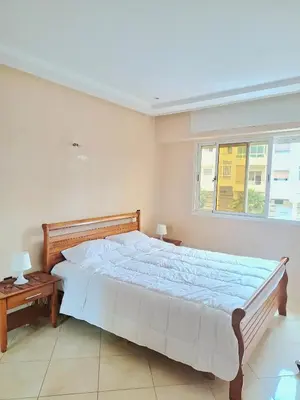 a bedroom with a large bed and a window at Apartment with sea view in El Harhoura