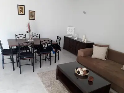 a living room with a couch and a table at Seaside apartment in El Mansouria in Mansouria
