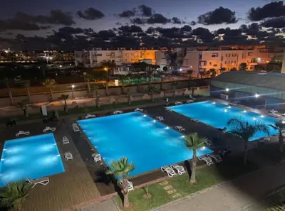 an overhead view of two swimming pools at night at Appartement de luxe avec piscine à Mansouria in Mansouria