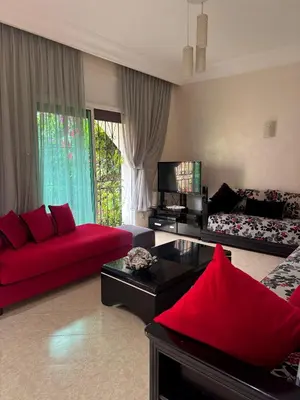 a living room with red furniture and a red couch at Villa Rina in Sidi Rahal